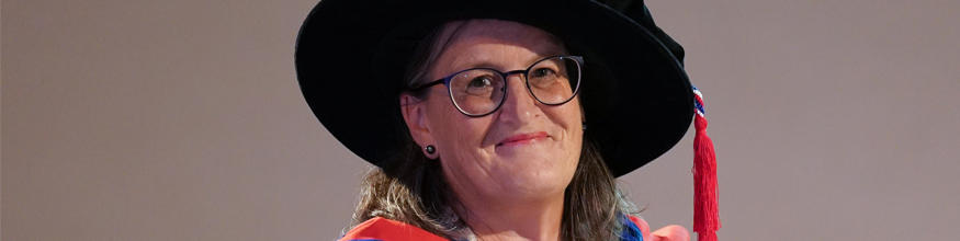 Head and shoulders of Chancellor Monica Grady wearing a cap